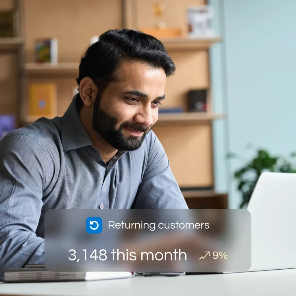 Smiling Doctor with laptop assessing returning customers by Marker Marketing