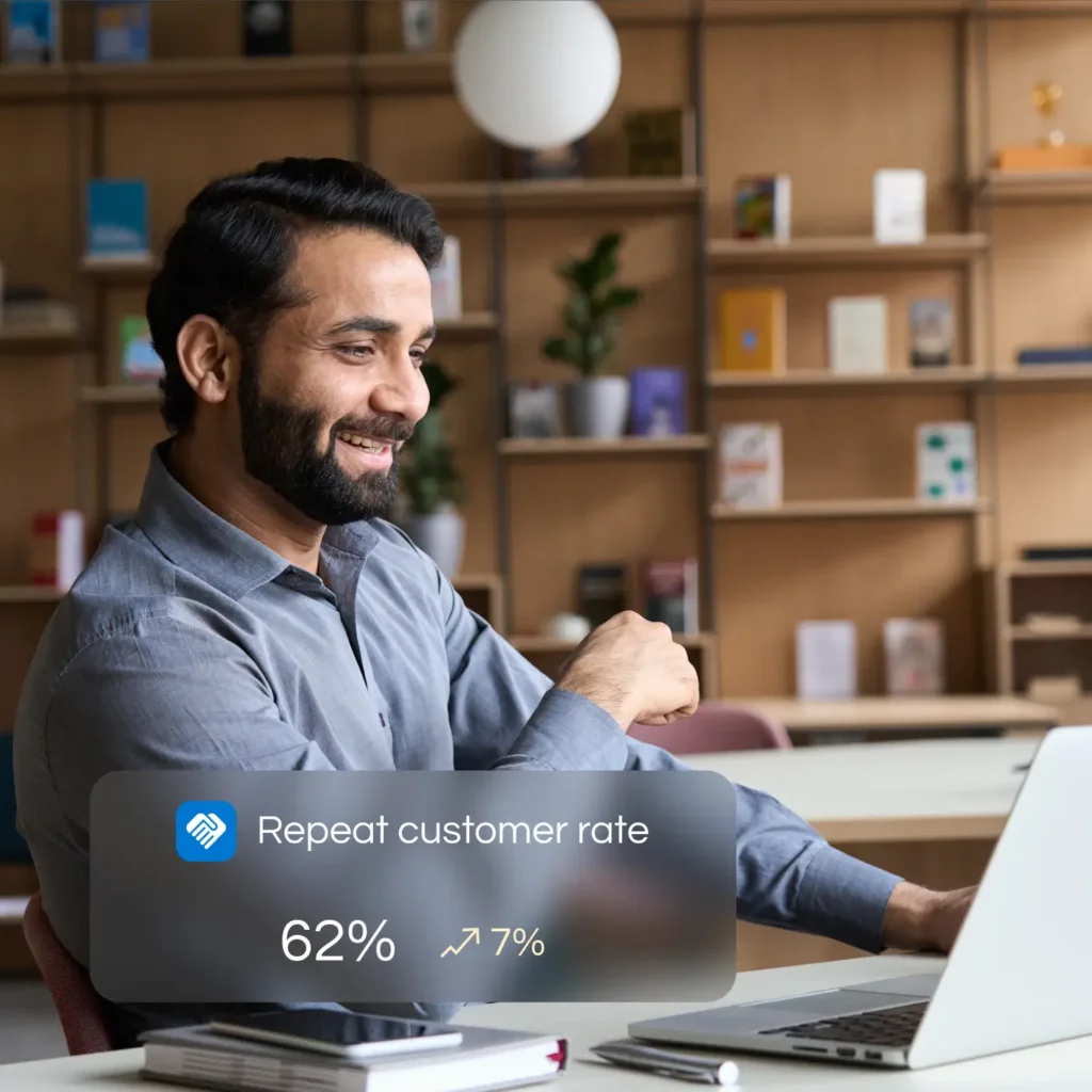 Smiling Practitioner with laptop assessing repeat customer rate by Marker Marketing
